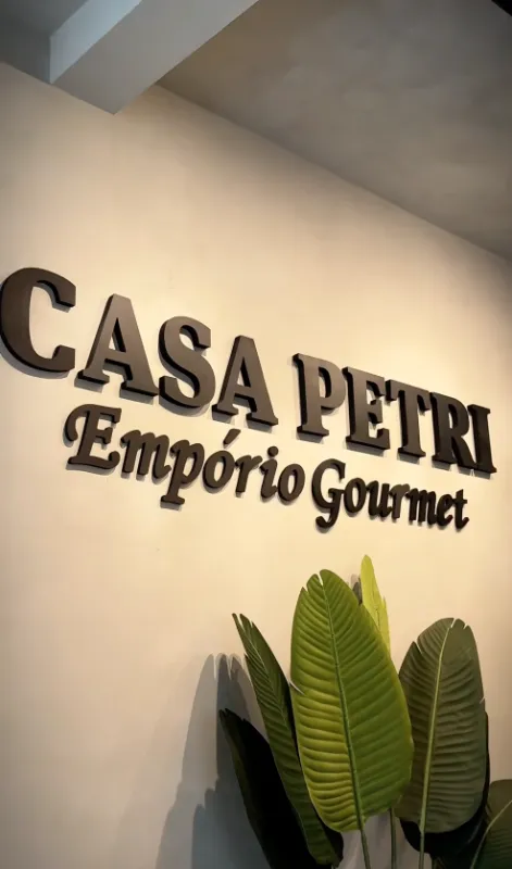 Parede interna da Casa Petri com o letreiro Casa Petri Empório Gourmet